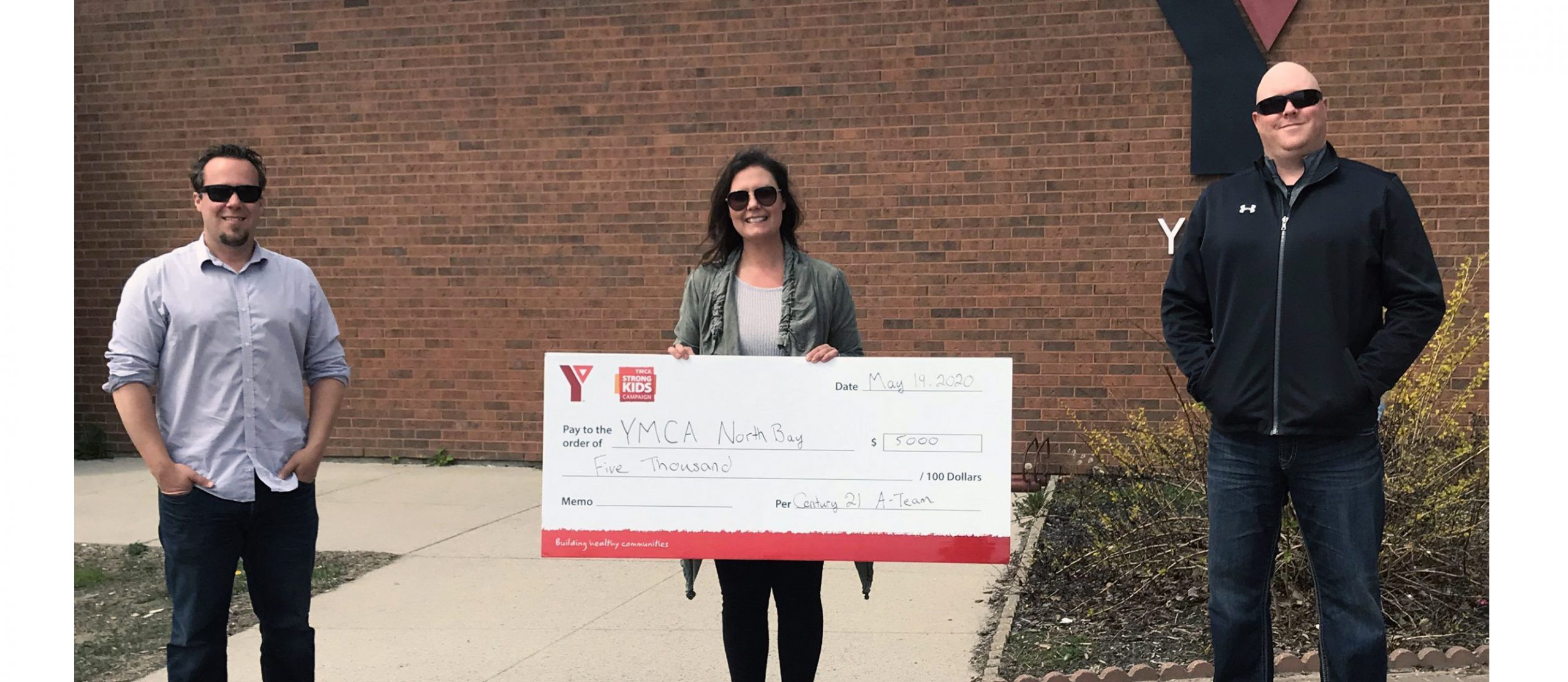A Team donates to YMCA
